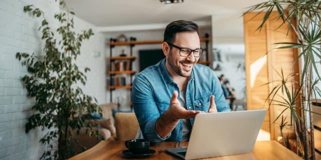 Man having video call on laptop computer.