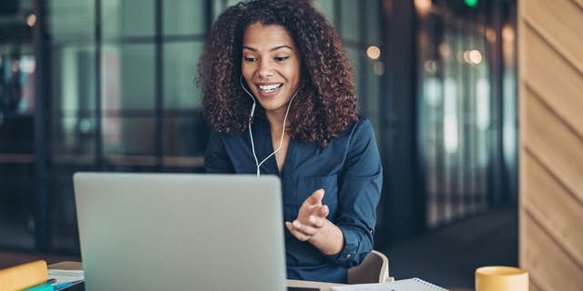 File photo of a a businesswoman on a laptop computer during a video call in the office
