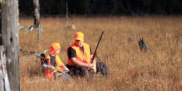 father and son are hunting