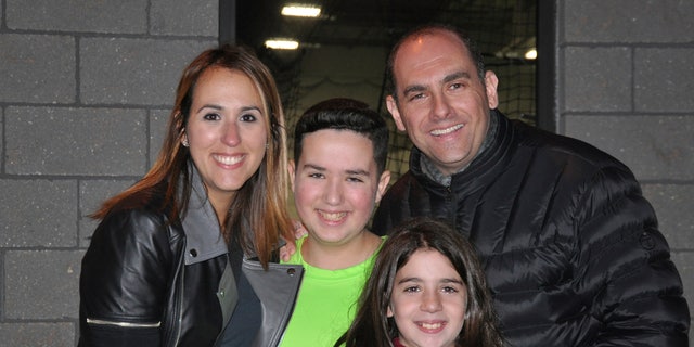 This 2016 photo provided by the family shows Jake Kestler, center, with his parents, Gallite and Josh, and his sister, Lily, a month before he was diagnosed with brain cancer. 