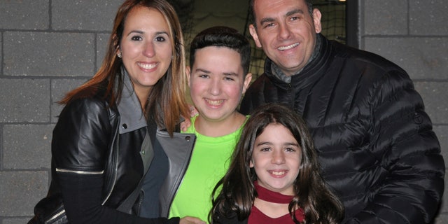 This 2016 photo provided by the family shows Jake Kestler, center, with his parents, Gallite and Josh, and his sister, Lily, a month before he was diagnosed with brain cancer.
