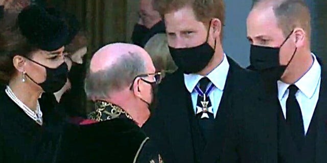 Kate Middleton, Prince Harry and Prince William stand close to one another following the Duke of Edinburgh's funeral service on Saturday.