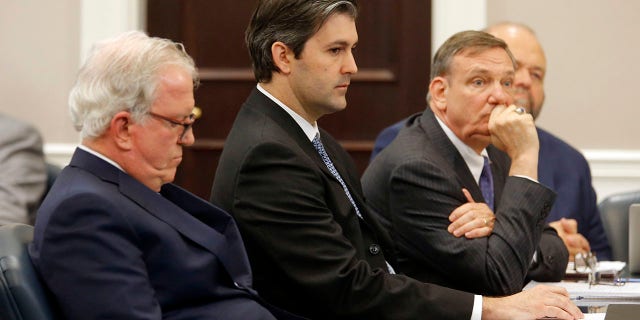 FILE - In this Dec. 5, 2016 file photo, defense attorneys Andy Savage, left, Don McCune, and Miller Shealy, right, sit around former North Charleston police officer Michael Slager at the Charleston County court in Charleston, S.C. (Grace Beahm/Post and Courier via AP, Pool)