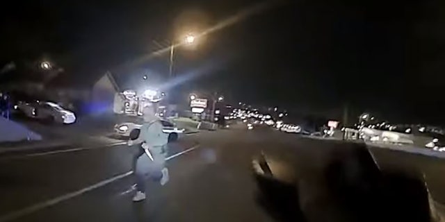 This screengrab taken from police body camera footage shows an unidentified man armed with at least one butcher knife running toward Officer Christopher Royer. (Metro Nashville Police Department)