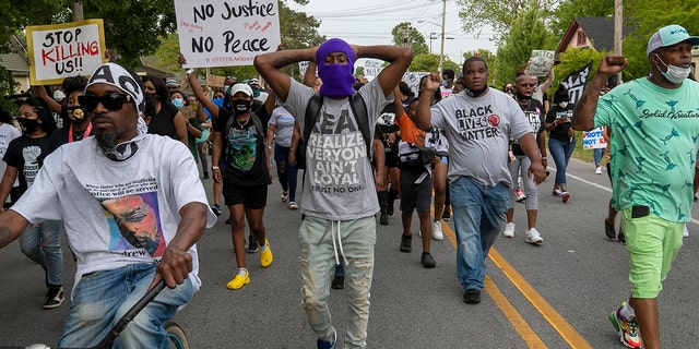 Elizabeth City Councilman Gabriel Adkins, second from right wearing a Black Lives Matter shirt, helps lead demonstrators on a march through Andrew Brown Jr.'s neighborhood, Thursday, April 29, 2021, in Elizabeth City, N.C. (Robert Willett/The News &amp; Observer via AP)