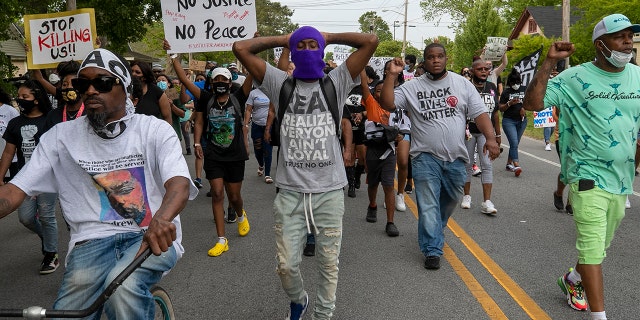 Elizabeth City Councilman Gabriel Adkins, second from right wearing a Black Lives Matter shirt, helps lead demonstrators on a march through Andrew Brown Jr.'s neighborhood, Thursday, April 29, 2021, in Elizabeth City, N.C. (Robert Willett/The News & Observer via AP)