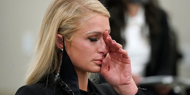 Paris Hilton wipes her eyes after speaking at a committee hearing at the Utah State Capitol, Monday, Feb. 8, 2021, in Salt Lake City. 