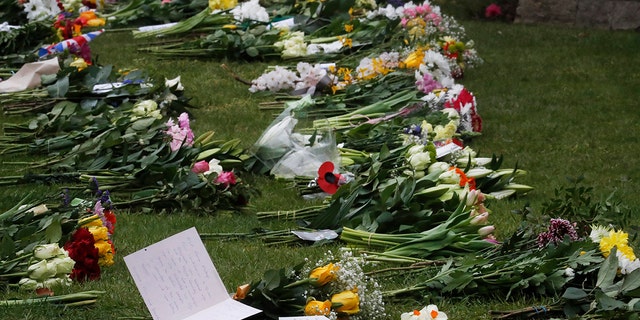 Flower tributes and notes left outside the gates of Windsor Castle, one day after the death of Britain's Prince Philip, in Windsor, England.