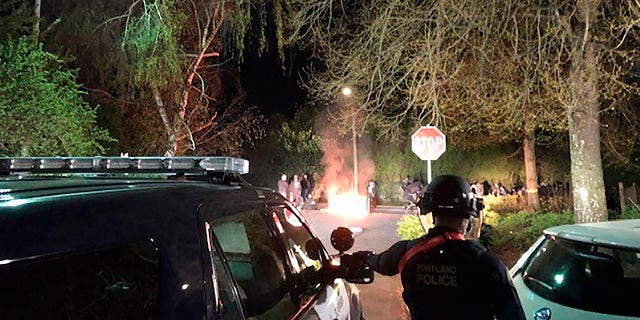 Portland police line up outside of the Penumbra Kelly Building in downtown Portland, Ore., on Monday. Police say a demonstration protesting the police killing of 20-year-old Daunte Wright in Minnesota turned into a riot, with some in the crowd throwing rocks and other projectiles at officers.