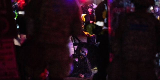 Law enforcement officers arrest a member of the media during the sixth night of protests over the shooting death of Daunte Wright by a police officer in Brooklyn Center, Minnesota on April 16, 2021. - Police officer, Kim Potter, who shot dead Black 20-year-old Daunte Wright in a Minneapolis suburb after appearing to mistake her gun for her Taser was arrested April 14 on manslaughter charges. (Photo by CHANDAN KHANNA / AFP) (Photo by CHANDAN KHANNA/AFP via Getty Images)