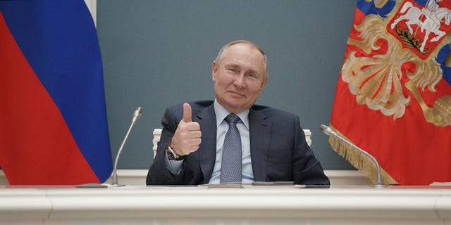 Russian President Vladimir Putin gives a thumbs-up as he attends a foundation-laying ceremony for the third reactor of the Akkuyu nuclear plant in Turkey March 10, 2021.