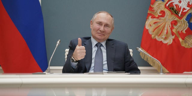 Russian President Vladimir Putin gives a thumbs-up as he attends a foundation-laying ceremony for the third reactor of the Akkuyu nuclear plant in Turkey March 10, 2021.