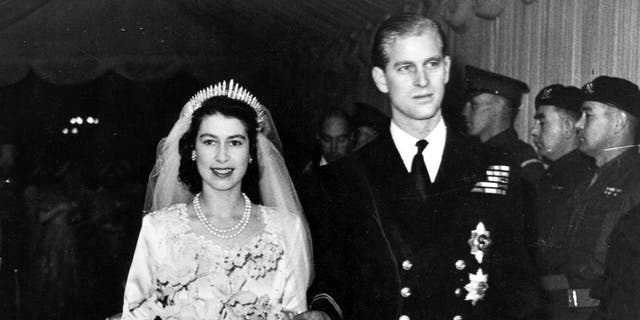 Queen Elizabeth II, as Princess Elizabeth, and her husband the Duke of Edinburgh, styled Prince Philip in 1957, on their wedding day. She became queen on her father King George VI's death in 1952. Philip died on Friday at the age of 99.