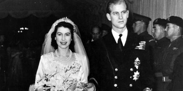 Queen Elizabeth II, as Princess Elizabeth, and her husband the Duke of Edinburgh, styled Prince Philip in 1957, on their wedding day. She became queen on her father King George VI's death in 1952. Philip died on Friday at the age of 99.