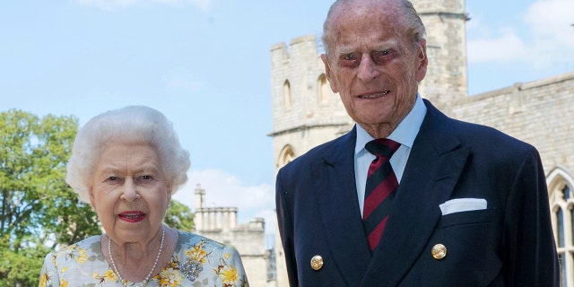 In this June 1, 2020 file photo, Britain's Queen Elizabeth II and Prince Philip pose for a photo in the quadrangle of Windsor Castle, in Windsor, England, ahead of his 99th birthday on Wednesday, June 10.