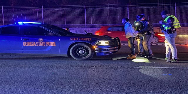 Smith, of Atlanta, is shown here being taken into custody. (Sandy Springs Police Department)