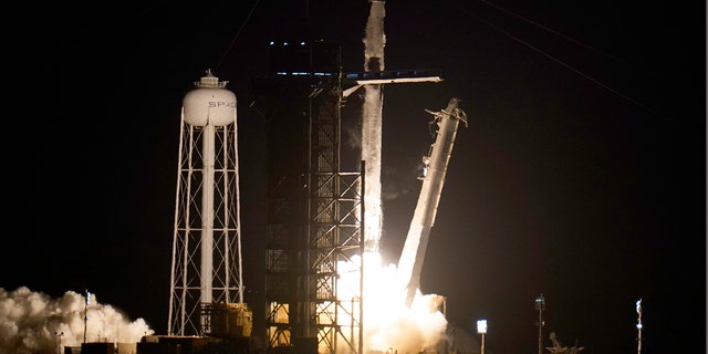 Raketa SpaceX Falcon 9 s vesmírnou kapsulou Kru Dragon vzlietla v piatok 39. apríla 2021 v Kennedyho vesmírnom stredisku v Cape Canaveral na Floride.  (AP Photo / John Roux)