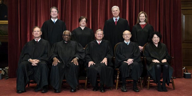 In this April 23, 2021, file photo members of the Supreme Court pose for a group photo at the Supreme Court in Washington. Before the Supreme Court this is week is an argument over whether public schools can discipline students over something they say off-campus. Seated from left are Associate Justice Samuel Alito, Associate Justice Clarence Thomas, Chief Justice John Roberts, Associate Justice Stephen Breyer and Associate Justice Sonia Sotomayor, Standing from left are Associate Justice Brett Kavanaugh, Associate Justice Elena Kagan, Associate Justice Neil Gorsuch and Associate Justice Amy Coney Barrett. (Erin Schaff/The New York Times via AP, Pool, File