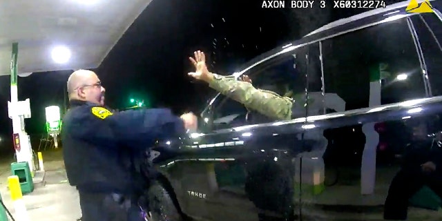 In this image made from Windsor, (Va.) Police video, A police officer uses a spray agent on Caron Nazario on Dec. 20, 2020, in Windsor, Va. Nazario, a second lieutenant in the U.S. Army, is suing two Virginia police officers over a traffic stop during which he says the officers drew their guns and pointed them at him as he was dressed in uniform. Caron Nazario says his constitutional rights were violated by the traffic stop in the town of Windsor in December. (Windsor Police via AP)