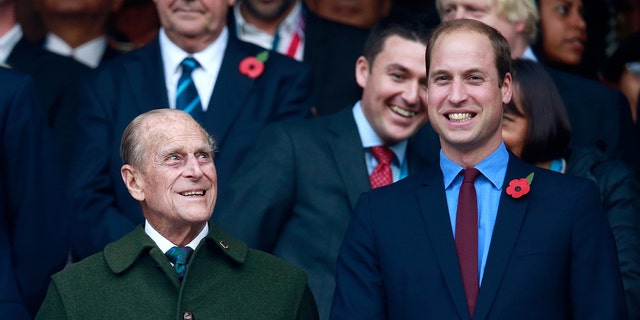 Prince Phillip (L) and Prince William (R) enjoy the build up to the 2015 Rugby World Cup Final match between New Zealand and Australia at Twickenham Stadium. 