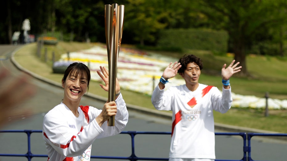 Olympic torch runs through empty park in Osaka as cases rise