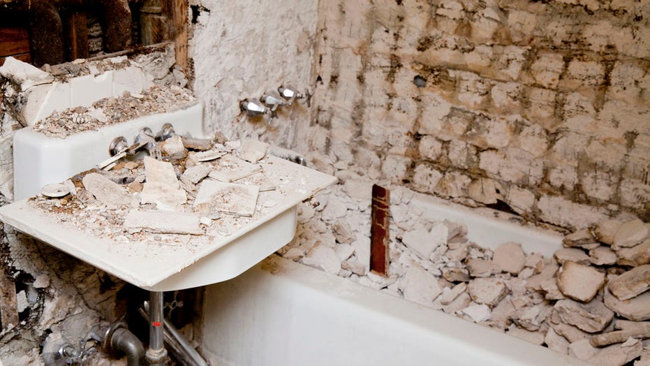 Homeowners find damaged shower walled up behind bathroom wall