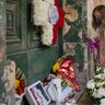 A woman lays flowers outside the old residence of Prince Phillip, Villa Guardamangia in Pieta, in Valletta, Malta, Saturday, April 17, 2021. Prince Philip, husband of Queen Elizabeth II, died Friday April 9 aged 99. His funeral service is taking place at St. George's Chapel inside Windsor Castle Saturday. (AP Photo/Rene' Rossignaud)