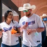 Fans walk through the concourse of Globe Life Field before the Texas Rangers home opener baseball game against the Toronto Blue Jays.