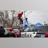 Protesters clash with police, Sunday, April 11, 2021, in Brooklyn Center, Minnesota. The family of Daunte Wright, 20, told a crowd that he was shot by police Sunday before getting back into his car and driving away, then crashing the vehicle several blocks away. The family said Wright was later pronounced dead.