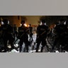 Officers stand guard outside Brooklyn Center Police Department with trash thrown at them by demonstrators at their feet after police allegedly shot and killed a man who local media report is identified by the victim's mother as Daunte Wright, in Brooklyn Center, Minnesota, April 11, 2021.