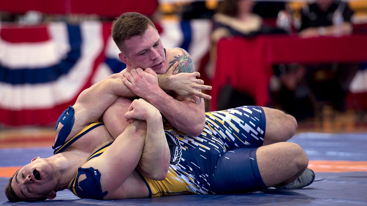 Marine Sgt. John Stefanowicz, from Kennerdell Pa., pins Navy Petty Officer Joseph Marques from Punta Gorda, Fla., during the 82 kg weight class of the 2018 Armed Forces Wrestling Championship Greco-Roman competition. (U.S. Navy photo by Mass Communication Specialist 1st Class Gulianna Dunn/Released)