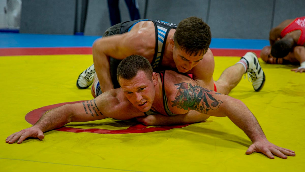U.S. Marine Corps Capt. Peyton Walsh, top, and Staff Sgt. John Stefanowicz, bottom, with the All-Marine Wrestling Team (AMWT), hone their wrestling techniques to prepare for the Olympic Trials, on Marine Corps Air Station New River, North Carolina, Jan. 8, 2021.