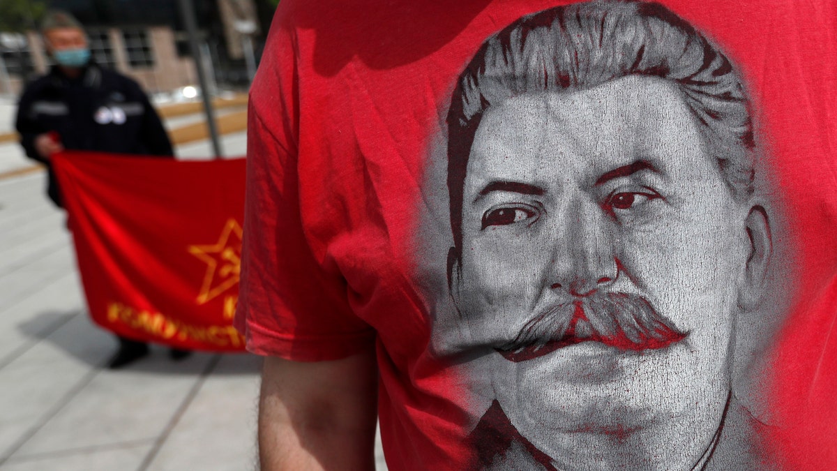 A man wearing a shirt with the image of former Soviet dictator Joseph Stalin attends May Day in Belgrade, Serbia. (AP Photo/Darko Vojinovic)