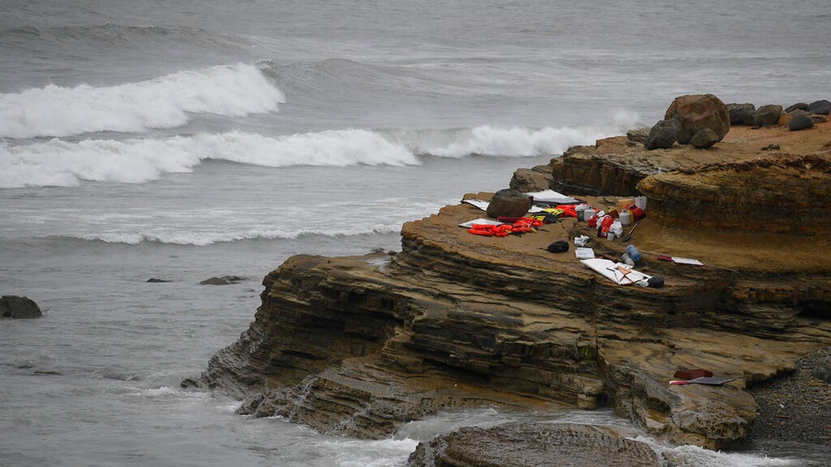 Items from a boat sit on the shoreline at Cabrillo National Monument near where it capsized just off the San Diego coast Sunday, May 2, 2021, in San Diego. 