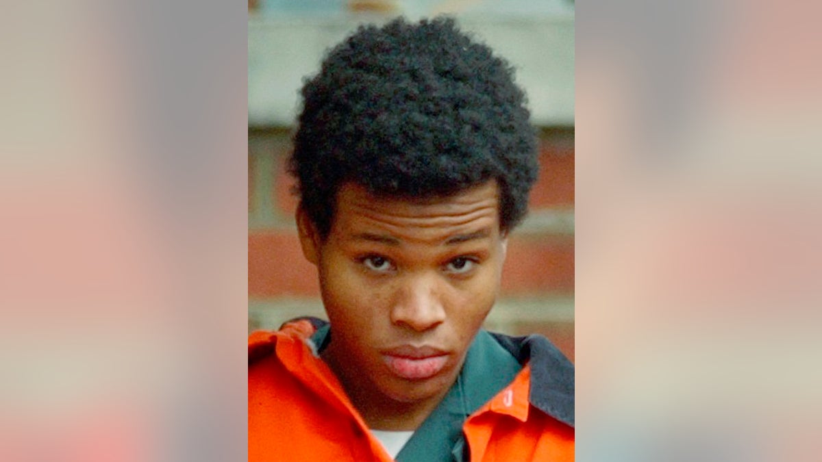FILE -- Lee Boyd Malvo is escorted out of Fairfax Juvenile and Domestic Relations Court after a hearing in Fairfax, Va. on Dec. 30, 2002. An eight-episode docuseries, "I, Sniper," features Malvo, half of a two-man sniper team that killed 10 and terrorized the Washington D.C. region in 2002. The filmmakers coaxed Malvo to examine his life over 17 hours of phone calls. The series starts Monday on Vice TV.  (AP Photo/Susan Walsh/file)