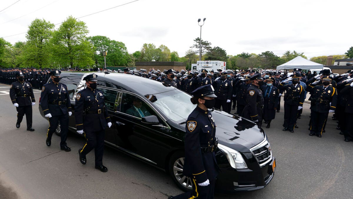 Thousands of police officers line the street as the hearse bearing New York police officer Anastasios Tsakos leaves the St. Paraskevi Greek Orthodox Shrine Church, Tuesday, May 4, 2021, in Greenlawn, N.Y. 