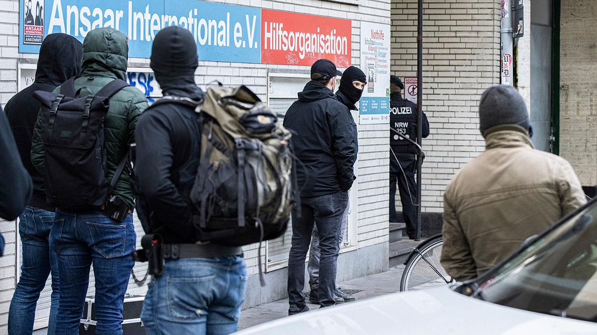 Police officers stay in front of a building of the Ansaar International association in Duesseldorf, Germany, Wednesday, May 5. 2021. (Marcel Kusch/dpa via AP)