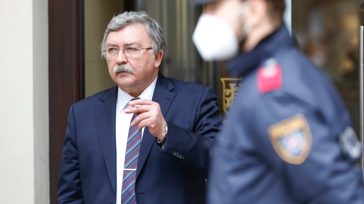 Russia's governor to the International Atomic Energy Agency (IAEA), Mikhail Ulyanov, has a cigarette break outside of the Grand Hotel Wien, where closed-door nuclear talks with Iran take place in Vienna, Austria, Friday, May 7, 2021. (AP Photo/Lisa Leutner)