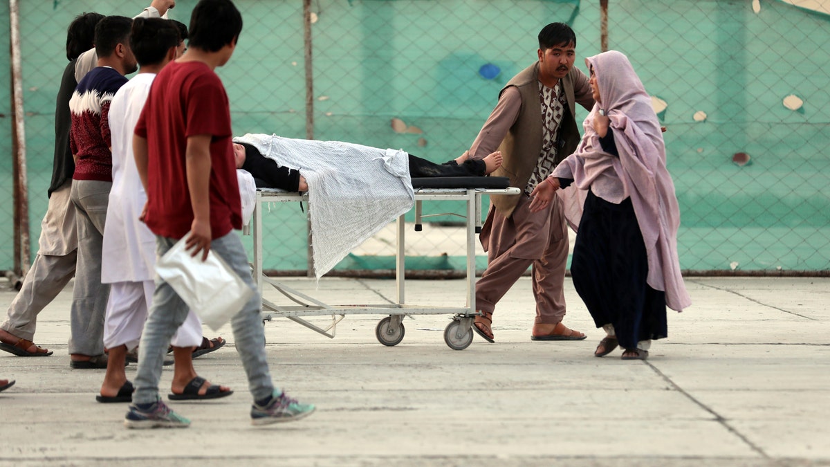 An injured school student is transported to a hospital after a bomb explosion near a school west of Kabul, Afghanistan, Saturday, May 8, 2021. A bomb exploded near a school in west Kabul on Saturday, killing several, many them young students, Afghan government spokesmen said. (AP Photo/Rahmat Gul)