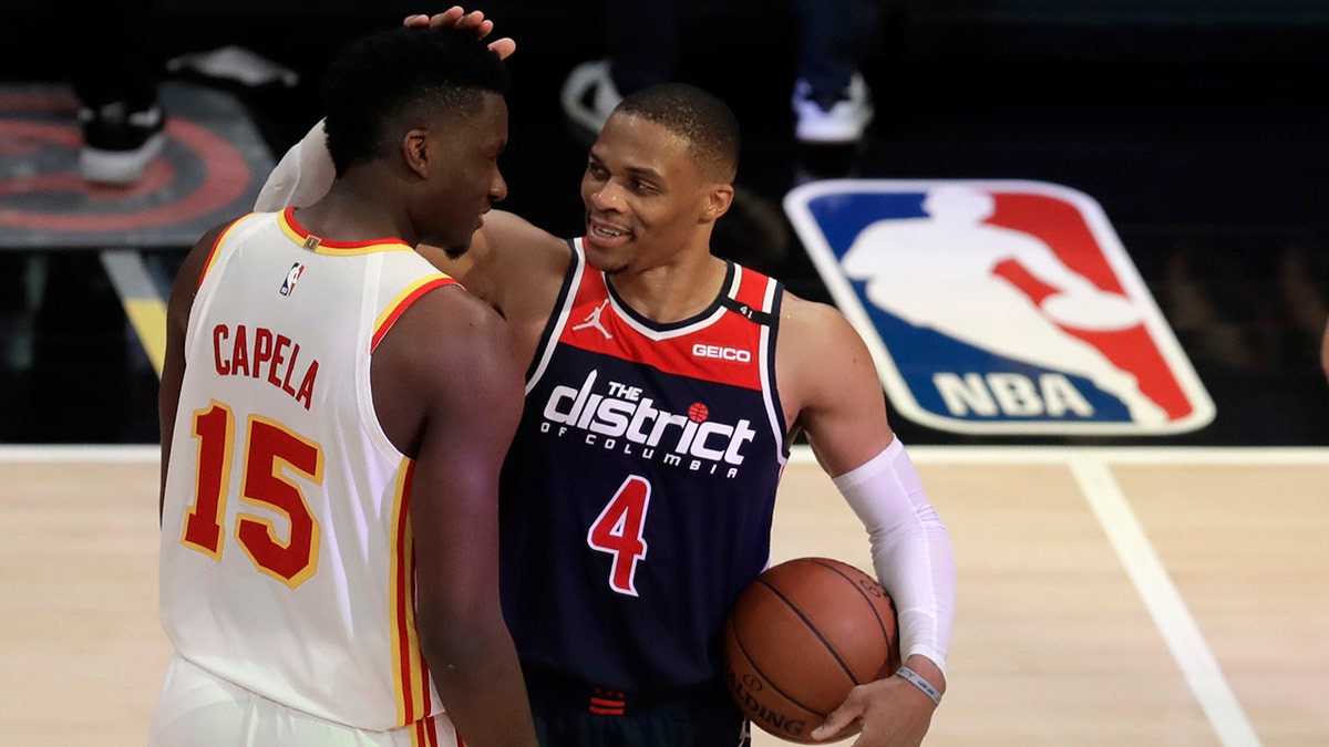 Washington Wizards' Russell Westbrook (4) is congratulated by Atlanta Hawks' Clint Capela at the end of an NBA basketball game Monday, May 10, 2021, in Atlanta. (AP Photo/Ben Margot)