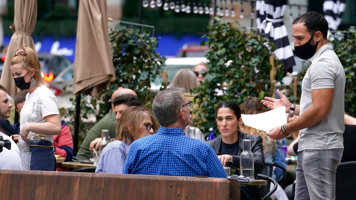 FILE: Patrons at a sidewalk cafe are seated without masks in Boston.?