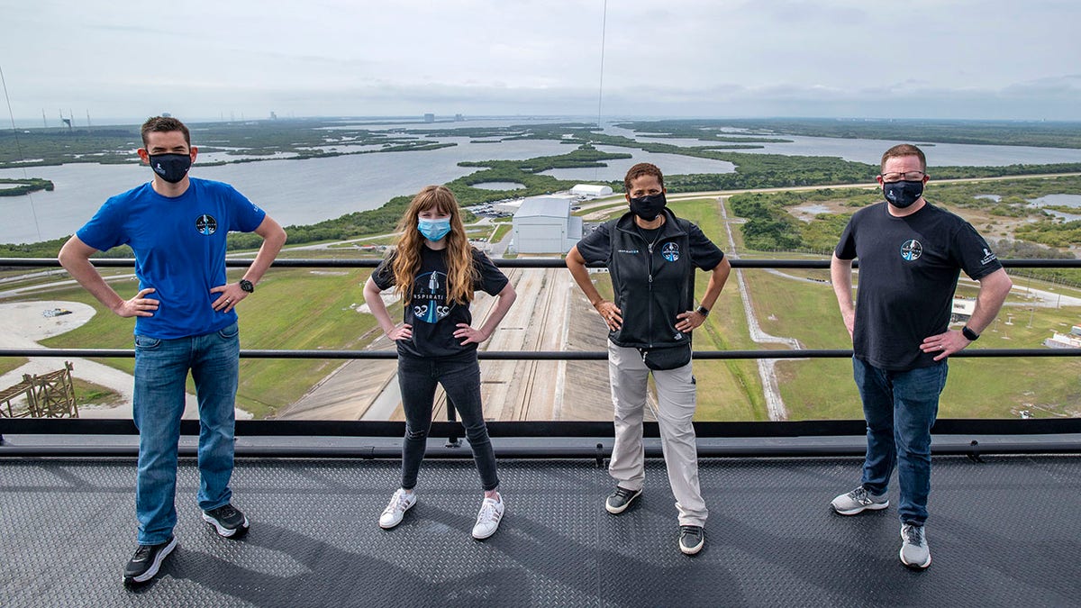 FILE - In this Monday, March 29, 2021 photo provided by SpaceX, from left, Jared Isaacman, Hayley Arceneaux, Sian Proctor and Chris Sembroski pose for a photo on the SpaceX launch tower at NASA's Kennedy Space Center at Cape Canaveral, Fla. SpaceX’s high tech capsules are completely automated, as are Blue Origin’s. So should wealthy riders and their guests be called astronauts even if they learn the ropes in case they need to intervene in an emergency? (SpaceX via AP, File)