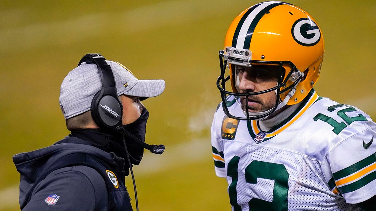 FILE - In this Jan. 3, 2021, file photo, Green Bay Packers head coach Matt LaFleur, left, talks to Aaron Rodgers during the second half of an NFL football game against the Chicago Bears in Chicago.