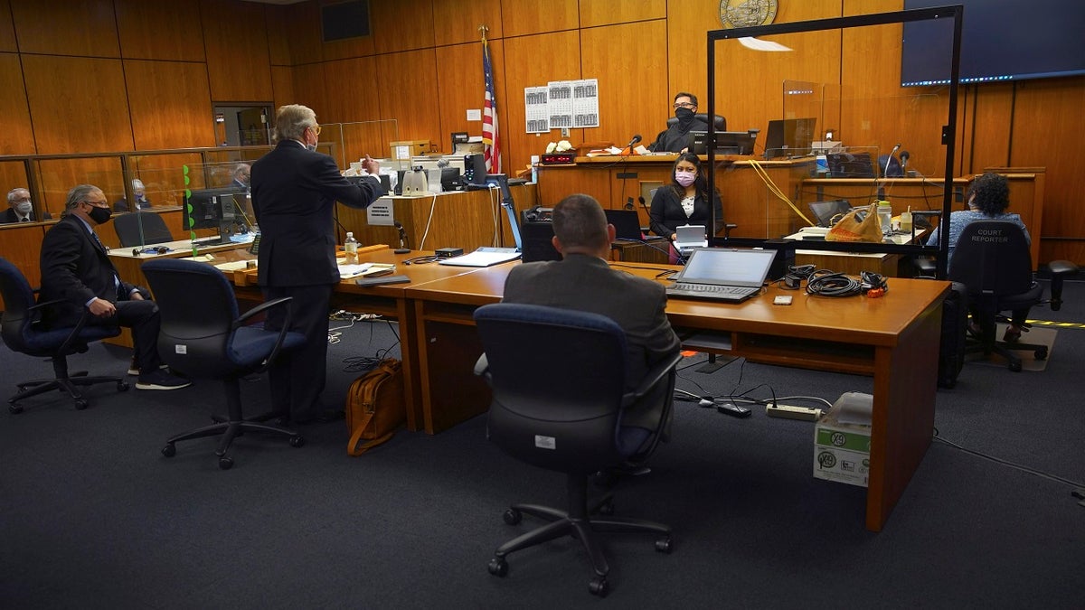 Defense attorney Dick DeGuerin, center standing, addresses Judge Mark Windham, center in back, alongside fellow defense attorney David Z. Chesnoff, left, and Deputy District Attorney John Lewin, at right, representing the prosecution, during the murder trial of Robert Durst Monday, May 17, 2021, in Inglewood, Calif. 