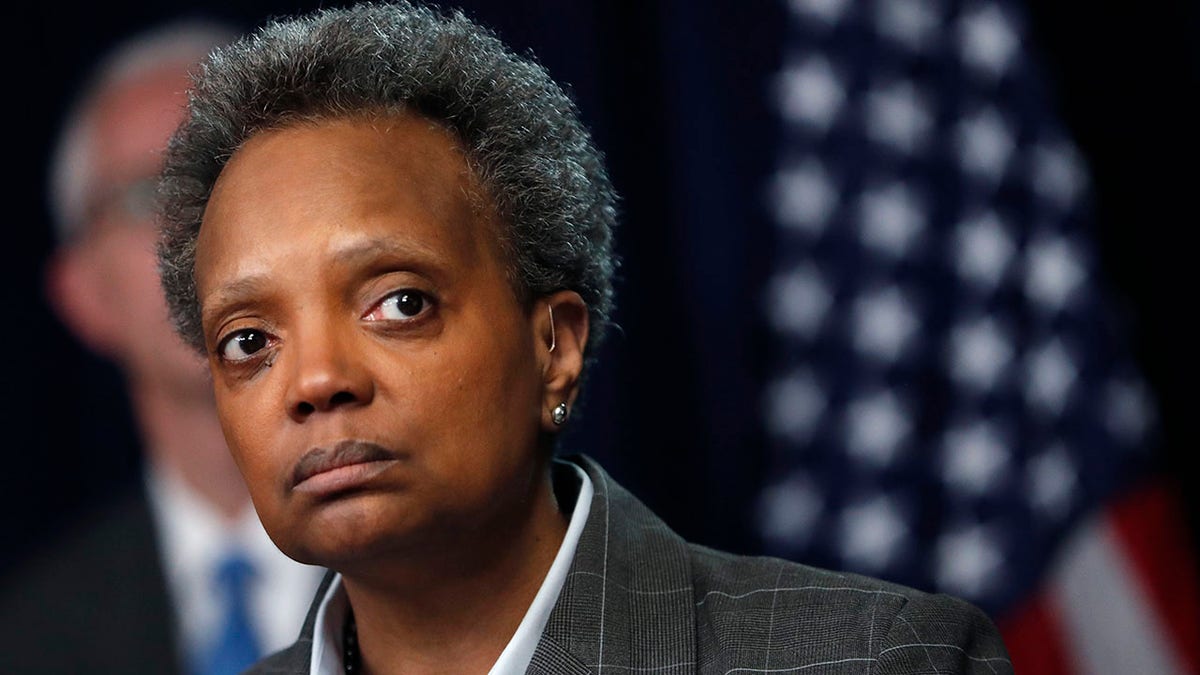 Chicago Mayor Lori Lightfoot looks at the camera while wearing a suit