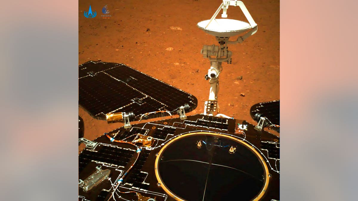 The rover's solar panels and antenna are deployed as the rover sits on its lander on the surface of Mars. 