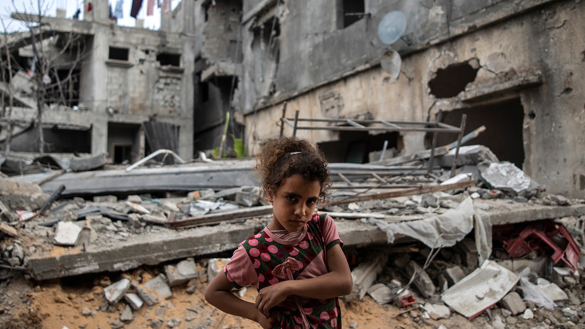 Palestinian Rahaf Nuseir, 10, looks on as she stands outside her family's destroyed homes, to which they returned following a cease-fire reached after an 11-day war between Gaza's Hamas rulers and Israel, in town of Beit Hanoun, northern Gaza Strip, Friday, May 21, 2021. (Associated Press)