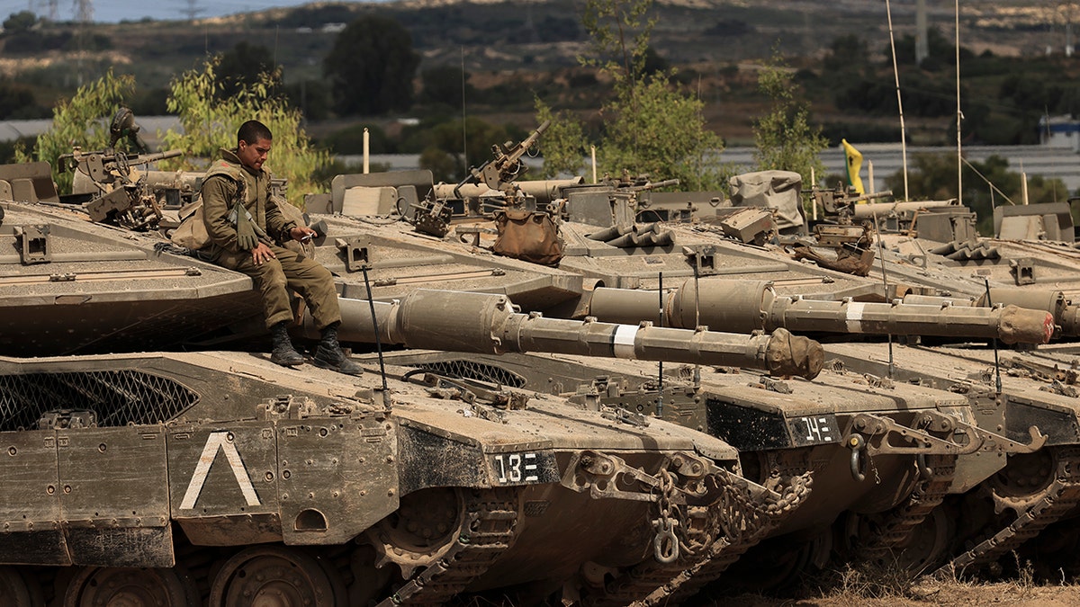 An Israeli soldier sits on top of a tank at a staging ground near the border with Gaza Strip, southern Israel, Friday, May 21, 2021. A cease-fire took effect early Friday after 11 days of heavy fighting between Israel and Gaza's militant Hamas rulers that was ignited by protests and clashes in Jerusalem. (Associated Press)
