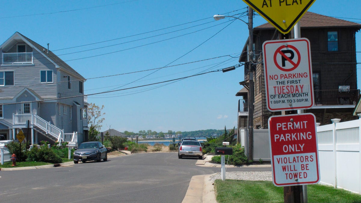 A sign is displayed on a side street in Sea Bright N.J. on May 15, 2021, restricting parking to those with a permit. Some shore towns in New Jersey and other states have used parking restrictions as a way to keep outsiders off their beaches. Sea Bright does offer a public parking lot near one beach. (AP Photo/Wayne Parry)