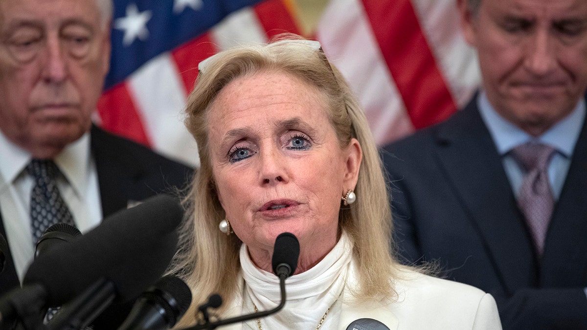 U.S. Rep. Debbie Dingell, D-Mich., speaks in Washington, accompanied by House Majority Leader Steny Hoyer of Maryland, left, and Rep. Matt Cartwright, D-Pa., Feb. 4, 2020. (Associated Press)